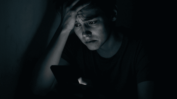 Person feeling overwhelmed by social media use at night
