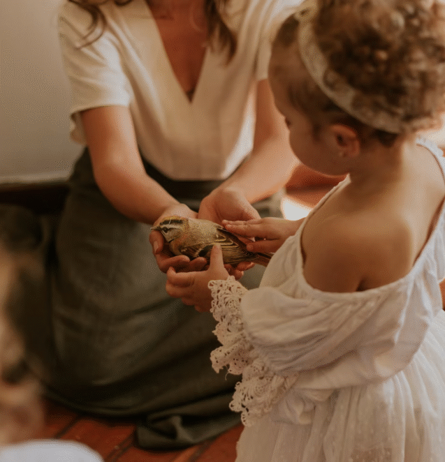 a parent teaching the child to care for a bed