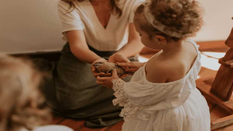 a parent teaching the child to care for a bed