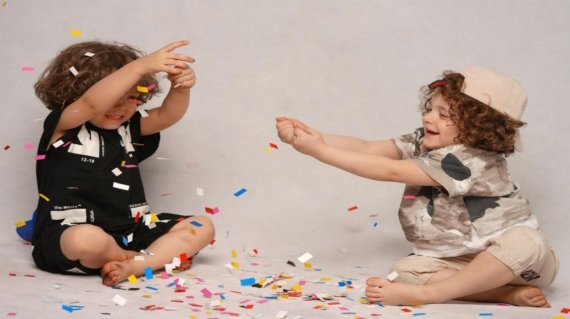 girl in black and white shirt playing with girl in white shirt