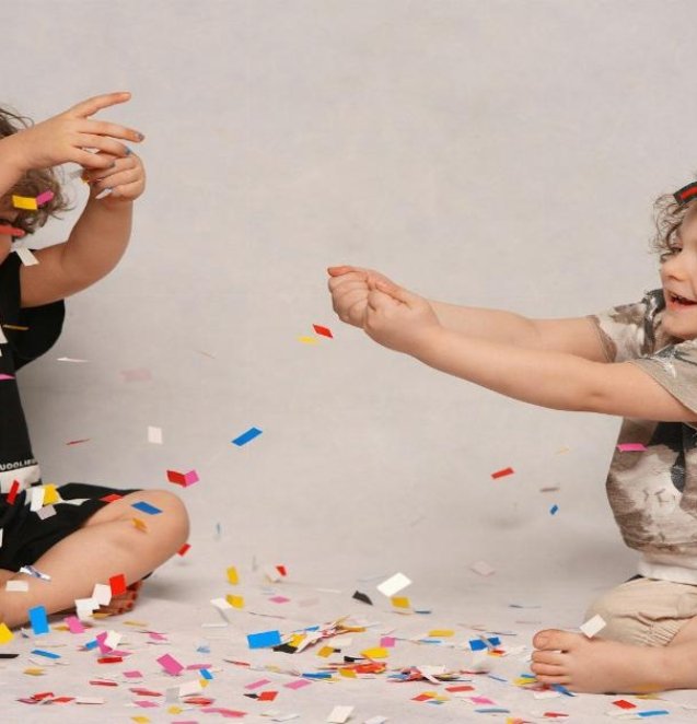 girl in black and white shirt playing with girl in white shirt