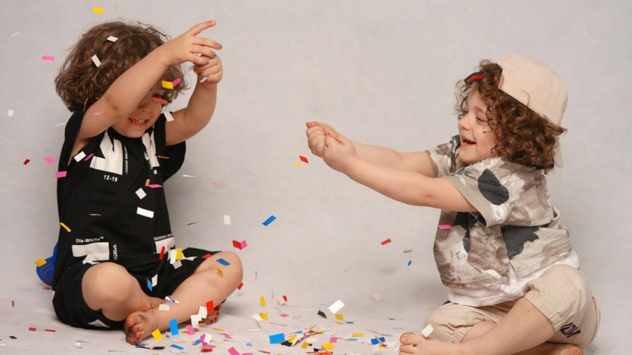 girl in black and white shirt playing with girl in white shirt