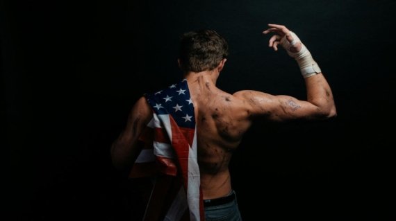 a man with an american flag on his back