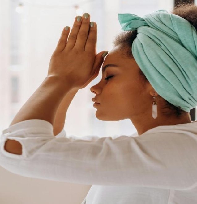 Woman practicing meditation indoors with a focus on relaxation and mindfulness.