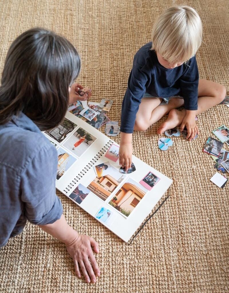 Parent teaching emotional intelligence to a child using emotion cards