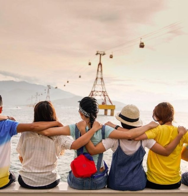 people holding shoulders sitting on wall