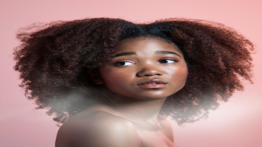 a woman with an afro is looking at the camera