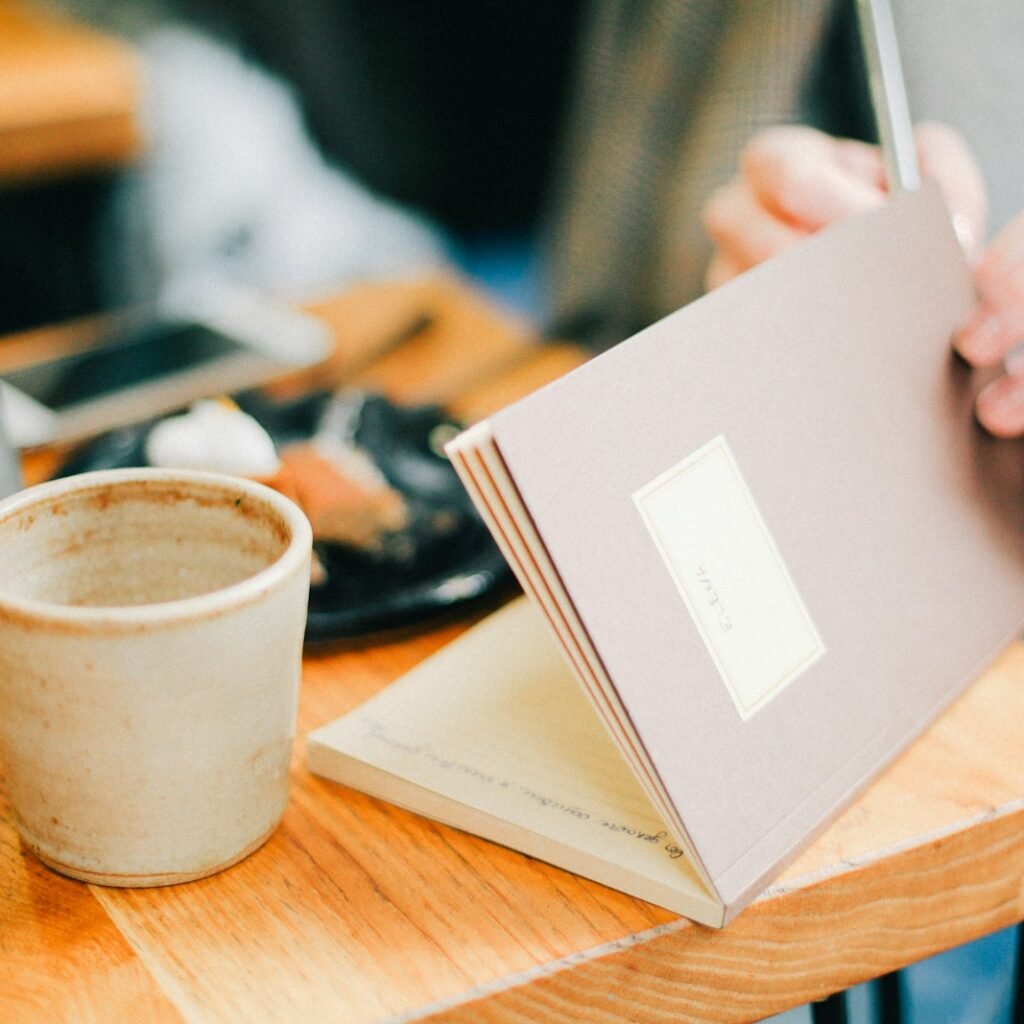 warm journal and tea cup representing self-care during emotional overwhelm
