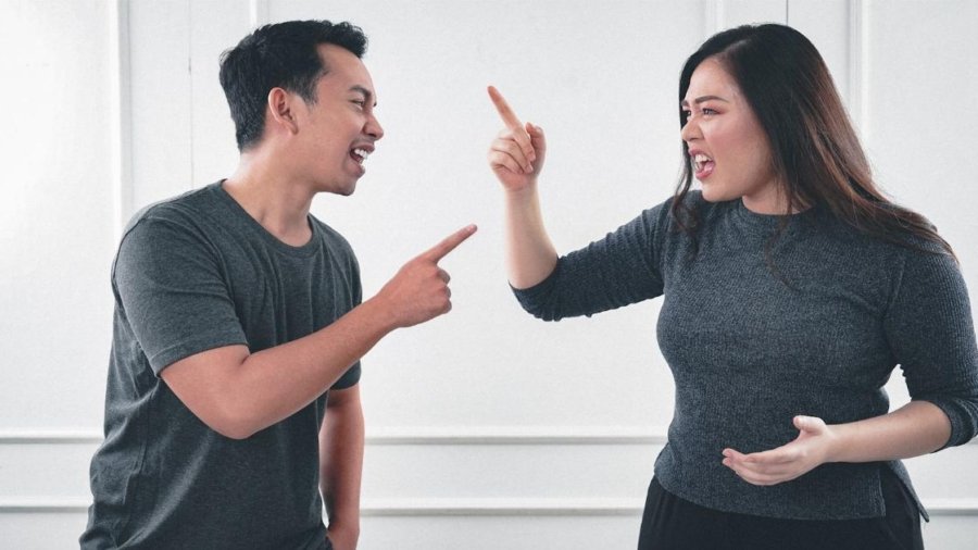 man in gray crew neck long sleeve shirt standing beside woman in black crew neck shirt