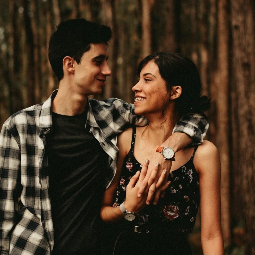 man wrapping arm on woman facing each other