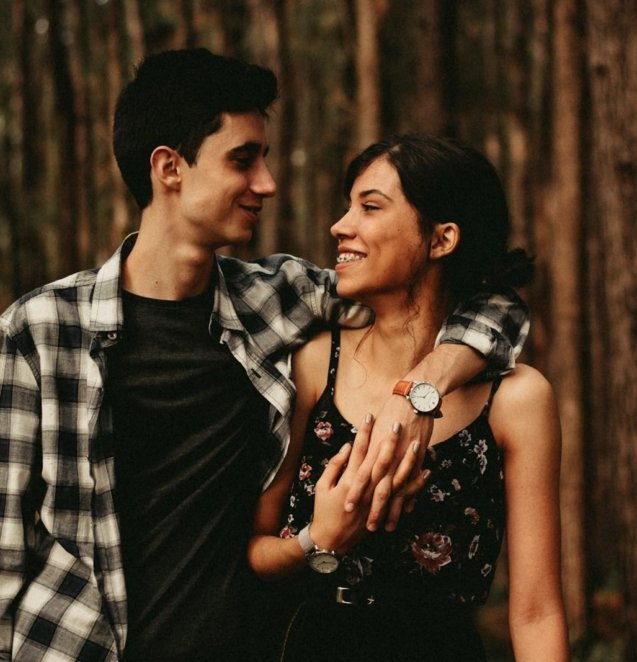 man wrapping arm on woman facing each other