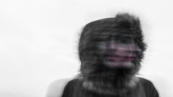 Creepy blurred photo of a person's face and a furry hood