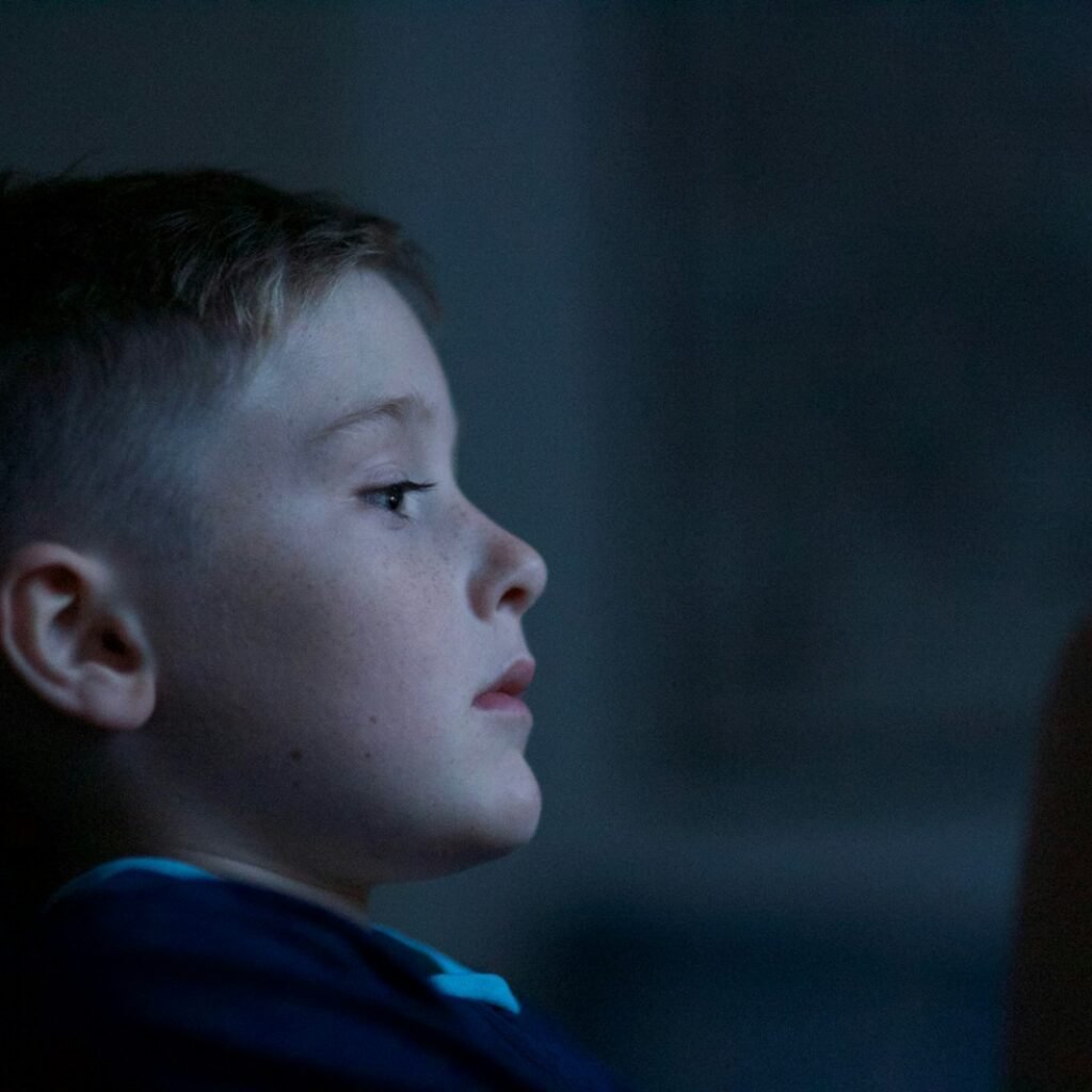 boy leaning on black wall